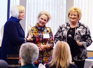 2017 Athena recipient Pam Hall receiving the Athena statue from program chair Diane Glassmeyer and WBC president Terri Martin.