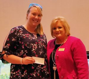 Maggie Breeding of the Boys & Girls Club accepting the check from WBC president Terri Martin