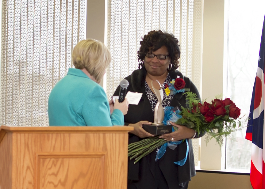 Arnita Pittman (right), Executive Director and Founder of the Arnita Pittman Community Recovery Center, receiving the ATHENA trophy from Diane Glassmeyer.