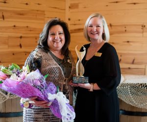 Beth Meadows (left) receives the 2020 ATHENA Award from Kathy Seckel.